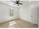 Bright bedroom with a ceiling fan, wood floors, and a large window at 5123 Oak Ridge Pl, Columbus, IN 47201