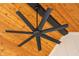 Close up of a black ceiling fan with a wood planked ceiling at 5123 Oak Ridge Pl, Columbus, IN 47201