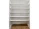 Walk-in closet featuring wood laminate floors and painted white shelving units at 5123 Oak Ridge Pl, Columbus, IN 47201