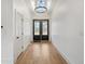 Bright foyer with wood floors, chandelier, skylight, and double glass front doors at 5123 Oak Ridge Pl, Columbus, IN 47201