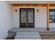 Close up of the double front doors framed by wood columns and inset lights at 5123 Oak Ridge Pl, Columbus, IN 47201