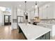 Modern kitchen with white cabinets, a gray island, stainless steel appliances, and a white countertop at 5123 Oak Ridge Pl, Columbus, IN 47201