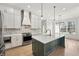 Bright, open kitchen featuring a large island with sink, stainless steel appliances, and elegant white cabinetry at 5123 Oak Ridge Pl, Columbus, IN 47201