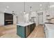 Spacious kitchen with modern cabinets, island, stainless appliances, and fireplace at 5123 Oak Ridge Pl, Columbus, IN 47201
