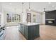 Open-concept kitchen boasts a large island, fireplace and lots of natural light at 5123 Oak Ridge Pl, Columbus, IN 47201