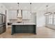 Open concept kitchen featuring stainless steel appliances, an island with sink, and hardwood floors at 5123 Oak Ridge Pl, Columbus, IN 47201