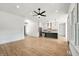 Bright, open-concept living area leading to a modern kitchen, ceiling fan, and lots of light at 5123 Oak Ridge Pl, Columbus, IN 47201