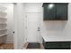 Bright mudroom with custom storage lockers, a bench, and easy access to the garage and pantry at 5123 Oak Ridge Pl, Columbus, IN 47201