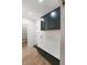 Mudroom with dark green cabinets, drawers, coat rack and hardwood floors at 5123 Oak Ridge Pl, Columbus, IN 47201