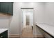 Mudroom with green cabinets, light countertops, and hardwood floors at 5123 Oak Ridge Pl, Columbus, IN 47201