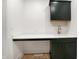 Mudroom with quartz counters, dark green cabinets, and hardwood flooring at 5123 Oak Ridge Pl, Columbus, IN 47201