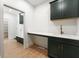Mudroom with dark green cabinets, quartz counters, and hardwood flooring at 5123 Oak Ridge Pl, Columbus, IN 47201