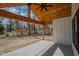 Covered outdoor patio with a wood ceiling and fan overlooks the backyard at 5123 Oak Ridge Pl, Columbus, IN 47201