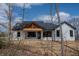 New construction modern farmhouse featuring a wood beam gable and black window trim at 5123 Oak Ridge Pl, Columbus, IN 47201