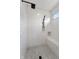 Tiled walk-in shower features a built-in bench and modern fixtures at 5123 Oak Ridge Pl, Columbus, IN 47201