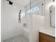 Modern bathroom features a white tiled shower with a bench and black hardware at 5123 Oak Ridge Pl, Columbus, IN 47201