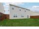 Backyard with green lawn, gray home exterior, and wooden fence at 5150 Bramwell Ln, Whitestown, IN 46075