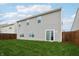 Green backyard of a gray siding house with wooden fence at 5150 Bramwell Ln, Whitestown, IN 46075