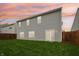 Backyard with green lawn, siding home, and wood fence at 5150 Bramwell Ln, Whitestown, IN 46075
