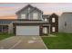 Charming two-story home featuring a two-car garage, brick accents, and a welcoming front lawn at 5150 Bramwell Ln, Whitestown, IN 46075