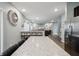 Bright, open-concept kitchen/living area with an island and barstool seating that flows into a comfortable living space at 5150 Bramwell Ln, Whitestown, IN 46075