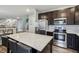 Stylish kitchen with dark cabinets, stainless steel appliances, and a granite-topped island with bar stools at 5150 Bramwell Ln, Whitestown, IN 46075