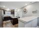 Modern kitchen with stainless steel appliances, dark cabinets, and a spacious island with a light countertop at 5150 Bramwell Ln, Whitestown, IN 46075