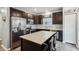 Stylish kitchen with stainless steel appliances, dark cabinetry, a kitchen island, and a bright window at 5150 Bramwell Ln, Whitestown, IN 46075