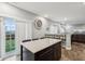 Modern kitchen with stainless steel appliances, dark cabinets, and a large island with barstool seating, lots of light at 5150 Bramwell Ln, Whitestown, IN 46075