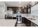 Functional kitchen with stainless steel appliances, granite countertops, dark cabinets and ample counter space at 5150 Bramwell Ln, Whitestown, IN 46075