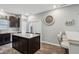 Well-lit kitchen featuring dark cabinets, stainless steel appliances, and a spacious island with barstool seating at 5150 Bramwell Ln, Whitestown, IN 46075