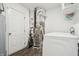 Laundry room with washer, dryer, and water heater with a white door and carpet cleaner at 5150 Bramwell Ln, Whitestown, IN 46075