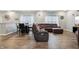 Open-concept living room and dining area with wood floors and comfortable seating at 5150 Bramwell Ln, Whitestown, IN 46075