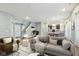 Open-concept living room with a view into the kitchen, showcasing a modern and connected living space at 5150 Bramwell Ln, Whitestown, IN 46075