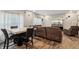Combined living and dining area with a TV, couch and a table with leather chairs at 5150 Bramwell Ln, Whitestown, IN 46075