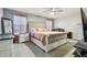 Spacious main bedroom featuring a decorative headboard, ceiling fan, and ample lighting at 5150 Bramwell Ln, Whitestown, IN 46075