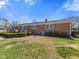 Backyard showing brick home with a patio and a small water tower at 5240 Magnolia Dr, Columbus, IN 47203