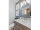 Bathroom with gray walls, marble countertop, and stylish lighting fixture at 5240 Magnolia Dr, Columbus, IN 47203