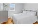 Bright bedroom with hardwood floors, a large window, and a comfortable bed at 5240 Magnolia Dr, Columbus, IN 47203