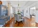 Charming dining room with hardwood floors and stylish, farmhouse furnishings at 5240 Magnolia Dr, Columbus, IN 47203