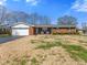 Traditional brick ranch with attached garage, cozy front porch, and classic curb appeal at 5240 Magnolia Dr, Columbus, IN 47203