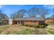 A charming brick home with a neatly manicured lawn and mature trees at 5240 Magnolia Dr, Columbus, IN 47203