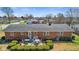Aerial view of a brick house showcasing the backyard with a lovely wooden deck at 5240 Magnolia Dr, Columbus, IN 47203