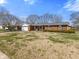 Lovely brick home featuring a well-manicured lawn and established trees at 5240 Magnolia Dr, Columbus, IN 47203