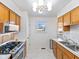 Bright kitchen boasts stainless steel appliances, modern backsplash, and convenient layout at 5240 Magnolia Dr, Columbus, IN 47203