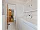 Bright laundry room with washer, dryer, and overhead storage at 5240 Magnolia Dr, Columbus, IN 47203