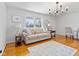 Inviting living room with wood floors, a comfortable couch, and a chandelier at 5240 Magnolia Dr, Columbus, IN 47203