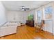 Sunlit living area featuring hardwood floors, a ceiling fan, and a comfortable sofa at 5240 Magnolia Dr, Columbus, IN 47203