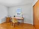 Cozy home office with a wooden desk, chair, and natural light from a window at 5240 Magnolia Dr, Columbus, IN 47203