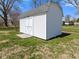 Well-maintained outbuilding with double doors, providing extra storage space at 5240 Magnolia Dr, Columbus, IN 47203